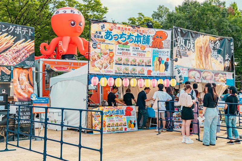 Japanese food stalls with various dishes at an outdoor festival