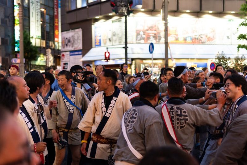 Lively Japanese street festival with participants in traditional clothing