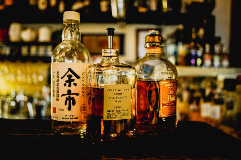 Selection of Japanese whisky bottles on bar shelves