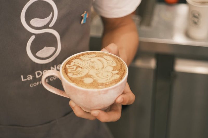 Close-up of cappuccino with latte art in a white cup