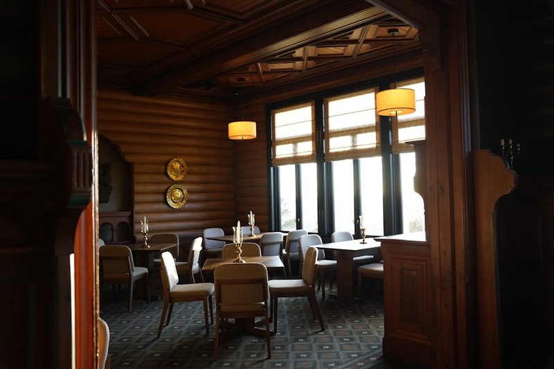 Warm rustic restaurant dining room with wooden walls and decor