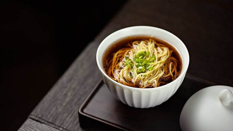 Japanese soba noodles served in dashi broth with garnish