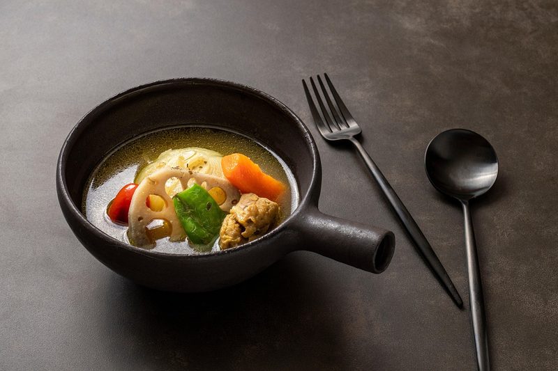 Bowl of hearty soup curry with vegetables