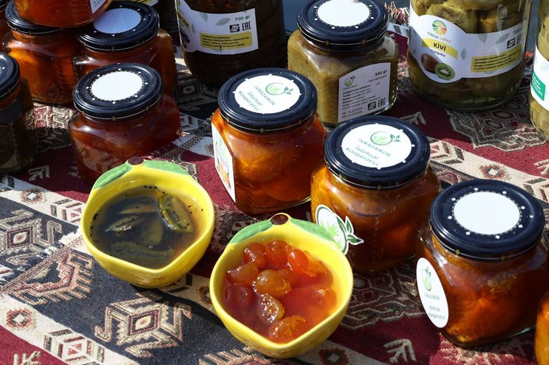Colorful jars of fruit preserves and jams on display