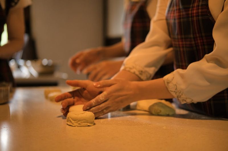Close-up of hands working dough in a cooking workshop