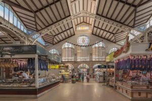 Bustling indoor food market with colorful fresh produce displays