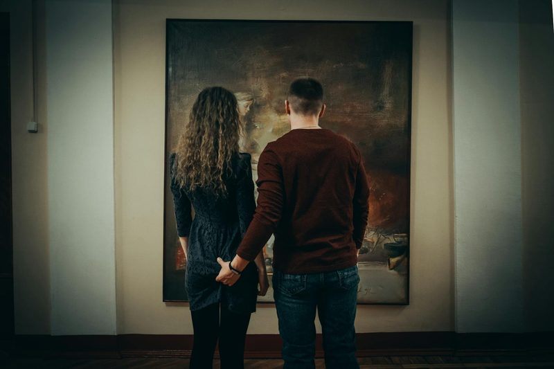 Visitors enjoying artwork in a museum gallery