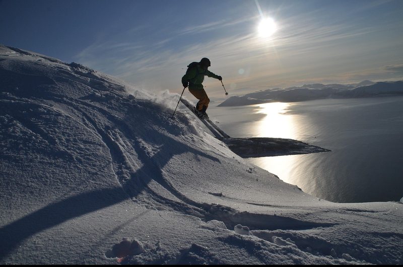 Skier descending a powder-covered mountain slope in Hokkaido
