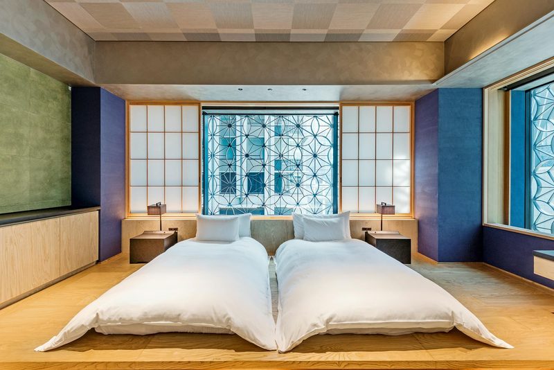 Modern Japanese hotel room with twin beds and wooden furnishings